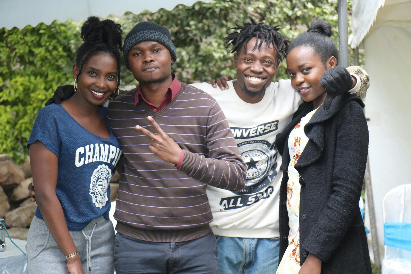 A group of friends smiling together outdoors in Nairobi, showing friendship and happiness.