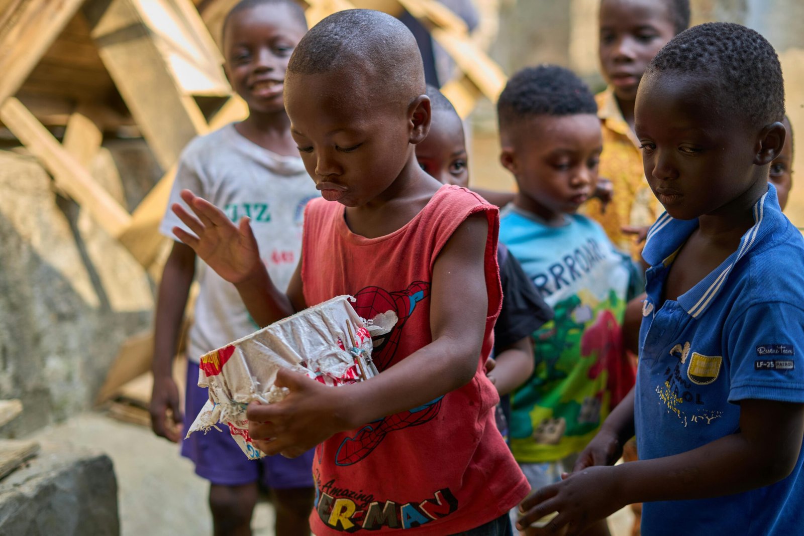 A joyful group of African children playing together outdoors, sharing smiles and friendship.